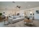Spacious open-concept living room with a large sofa, stylish decor, and ample natural light at 20277 W Highland Ave, Litchfield Park, AZ 85340