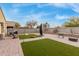 Spacious backyard area with patio, synthetic grass, and gravel at 2110 S 102Nd Ln, Tolleson, AZ 85353