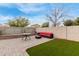 An inviting outdoor space features a patio area and synthetic grass at 2110 S 102Nd Ln, Tolleson, AZ 85353