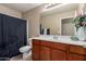 Bright bathroom featuring tile floor, shower/bath, single sink, and wood cabinet at 2110 S 102Nd Ln, Tolleson, AZ 85353