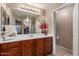 Inviting bathroom featuring neutral colors, mirror, and wood cabinets at 2110 S 102Nd Ln, Tolleson, AZ 85353