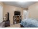 Cozy bedroom features carpet, tv, a sports helmet, and a dresser at 2110 S 102Nd Ln, Tolleson, AZ 85353