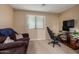 Relaxing bonus room featuring a comfortable sofa, gaming chair, and entertainment setup for leisure at 2110 S 102Nd Ln, Tolleson, AZ 85353