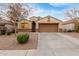 Attractive single-Gathering home showcasing a two-car garage, desert landscaping, and a well-maintained lawn at 2110 S 102Nd Ln, Tolleson, AZ 85353