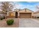 Charming single-story home featuring a two-car garage, gravel landscaping, and a neutral color palette at 2110 S 102Nd Ln, Tolleson, AZ 85353