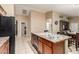 Spacious kitchen island featuring a stainless steel sink, ample counter space, and modern cabinetry at 2110 S 102Nd Ln, Tolleson, AZ 85353
