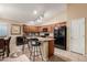 Spacious kitchen features wood cabinets, tile floor, and black appliances at 2110 S 102Nd Ln, Tolleson, AZ 85353