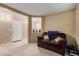 Cozy living area featuring a plush sofa, neutral carpet, and a bright, welcoming atmosphere at 2110 S 102Nd Ln, Tolleson, AZ 85353