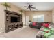 Spacious living room with large entertainment center and a comfortable sofa at 2110 S 102Nd Ln, Tolleson, AZ 85353