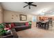 Comfortable living room and eating area featuring tile and carpet floors and fan at 2110 S 102Nd Ln, Tolleson, AZ 85353
