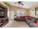 Inviting living room featuring a comfortable sectional sofa, ceiling fan, and natural light at 2110 S 102Nd Ln, Tolleson, AZ 85353