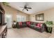Cozy living room featuring vaulted ceiling, fan, and large sofa at 2110 S 102Nd Ln, Tolleson, AZ 85353