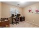 Functional office with natural light, a modern desk setup, and a cozy, carpeted space at 2110 S 102Nd Ln, Tolleson, AZ 85353