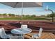 View from table towards community basketball court and green lawn in the background on a sunny day with blue sky at 2232 W Chisum Trl, Phoenix, AZ 85085