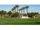 A lush community park featuring tall palm trees, landscaped grounds, and a shaded pavilion at 2232 W Chisum Trl, Phoenix, AZ 85085