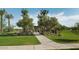 Pathway through lush green grass and mature trees, leading to picnic benches, in the community park at 2232 W Chisum Trl, Phoenix, AZ 85085