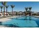 Community pool with cabanas and lounge chairs, surrounded by palm trees at 2232 W Chisum Trl, Phoenix, AZ 85085