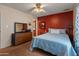 A bright bedroom with a large bed and a matching dresser at 2349 W Shaw Butte Dr, Phoenix, AZ 85029