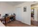 Bedroom featuring a desk with chair, closet doors and view into another room at 2349 W Shaw Butte Dr, Phoenix, AZ 85029