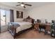 A bedroom with a large wooden bed, side table and desk with chair at 2349 W Shaw Butte Dr, Phoenix, AZ 85029