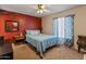 Comfortable bedroom with a large bed, neutral carpet and bold accent wall at 2349 W Shaw Butte Dr, Phoenix, AZ 85029