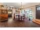 Charming dining area with dark wood floors and views into the kitchen at 2349 W Shaw Butte Dr, Phoenix, AZ 85029