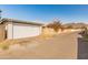 Garage with white door near a block wall and bougainvillea in a residential neighborhood at 2349 W Shaw Butte Dr, Phoenix, AZ 85029