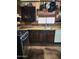 Functional kitchen boasts dark wood cabinets, stainless steel oven, and granite countertops at 2349 W Shaw Butte Dr, Phoenix, AZ 85029