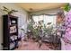 Bright living room filled with lush indoor plants and natural light from a large window at 2349 W Shaw Butte Dr, Phoenix, AZ 85029