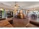 Open-concept living room featuring hardwood floors, a piano, and views of the dining area at 2349 W Shaw Butte Dr, Phoenix, AZ 85029