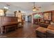 Spacious living room with hardwood floors, a fireplace, and a vintage piano at 2349 W Shaw Butte Dr, Phoenix, AZ 85029