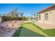 Spacious backyard with manicured grass, desert landscaping and a view of a beautiful outdoor area at 2602 E Glass Ln, Phoenix, AZ 85042