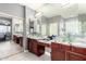 Bright bathroom featuring double sinks with stylish glass bowls and updated countertops, plus a glass enclosed shower at 2602 E Glass Ln, Phoenix, AZ 85042