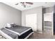Clean bedroom featuring carpet, ceiling fan, closet, and a gray comforter on the bed, plus white trim at 2602 E Glass Ln, Phoenix, AZ 85042
