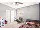 Clean bedroom featuring a ceiling fan, plush carpet, plus a chair and black platform bed frame at 2602 E Glass Ln, Phoenix, AZ 85042