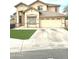 Charming two-story home with a well-manicured lawn and attached two-car garage and desert landscaping at 2602 E Glass Ln, Phoenix, AZ 85042