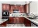 Kitchen featuring wood cabinets, granite countertops, and stainless steel appliances and luxury vinyl plank flooring at 2602 E Glass Ln, Phoenix, AZ 85042