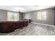 Spacious living room with wood-look flooring, a ceiling fan, and a large window with natural light at 2602 E Glass Ln, Phoenix, AZ 85042