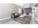 Nicely furnished living room with a sofa, accent chair, decorative rug, and modern artwork at 2602 E Glass Ln, Phoenix, AZ 85042