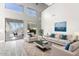 Bright living room with high ceilings and large sliding doors to the outdoor patio at 2602 E Glass Ln, Phoenix, AZ 85042