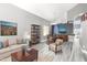 Open-concept living room featuring modern decor, a neutral color palette, and dining space at 2602 E Glass Ln, Phoenix, AZ 85042