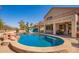 Resort-style pool area with a spa, rock features, and lush landscaping at 2602 E Glass Ln, Phoenix, AZ 85042
