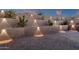 This backyard is beautifully landscaped with subtle lighting and a terraced design that highlights the natural beauty of the property at 26885 N 87Th Dr, Peoria, AZ 85383