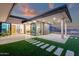 Inviting outdoor living space with patio, lush lawn, and stunning mountain views at dusk at 26885 N 87Th Dr, Peoria, AZ 85383