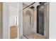 Glass-enclosed shower with dual shower heads and modern tiling at 26885 N 87Th Dr, Peoria, AZ 85383