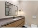 Elegant bathroom featuring a stylish vanity with pendant lighting and decorative mirror at 26885 N 87Th Dr, Peoria, AZ 85383