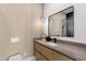 Elegant bathroom featuring a stylish vanity with pendant lighting and decorative mirror at 26885 N 87Th Dr, Peoria, AZ 85383
