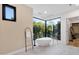 Modern bathroom with a soaking tub, large window, and natural light at 26885 N 87Th Dr, Peoria, AZ 85383