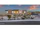 Desert home featuring a modern design with stacked stone accents, landscaped grounds, and a large garage at 26885 N 87Th Dr, Peoria, AZ 85383