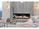 Living room fireplace featuring a modern design with ambient lighting and stylish decor at 26885 N 87Th Dr, Peoria, AZ 85383